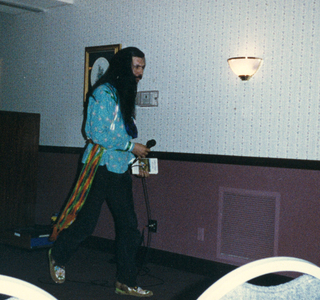 Ken Edwards walking to the podium with microphone