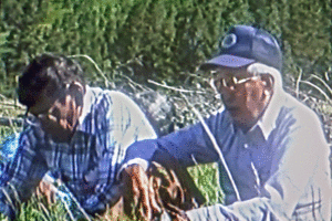 Two men, Robert and Wold Child sit in the grass