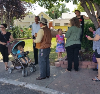  A group gathers on the sidewalk