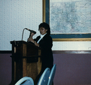 Sue Savage at the podium at the premiere screening of Indian Tears of Love